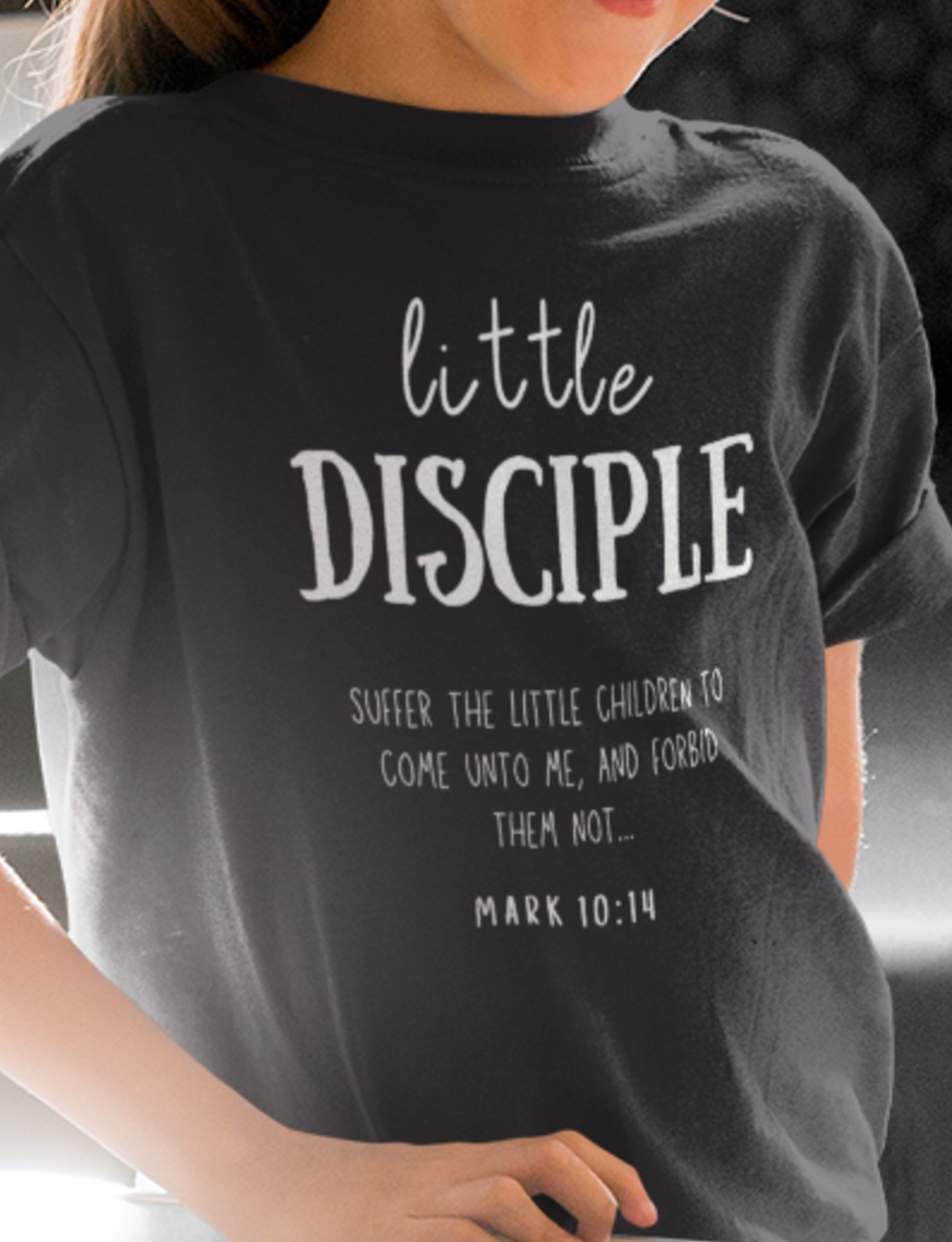 Black kid's Christian Mother's Day T-shirt with "Little Disciple" print design. Crew neck, short-sleeved, unisex, classic retail fit