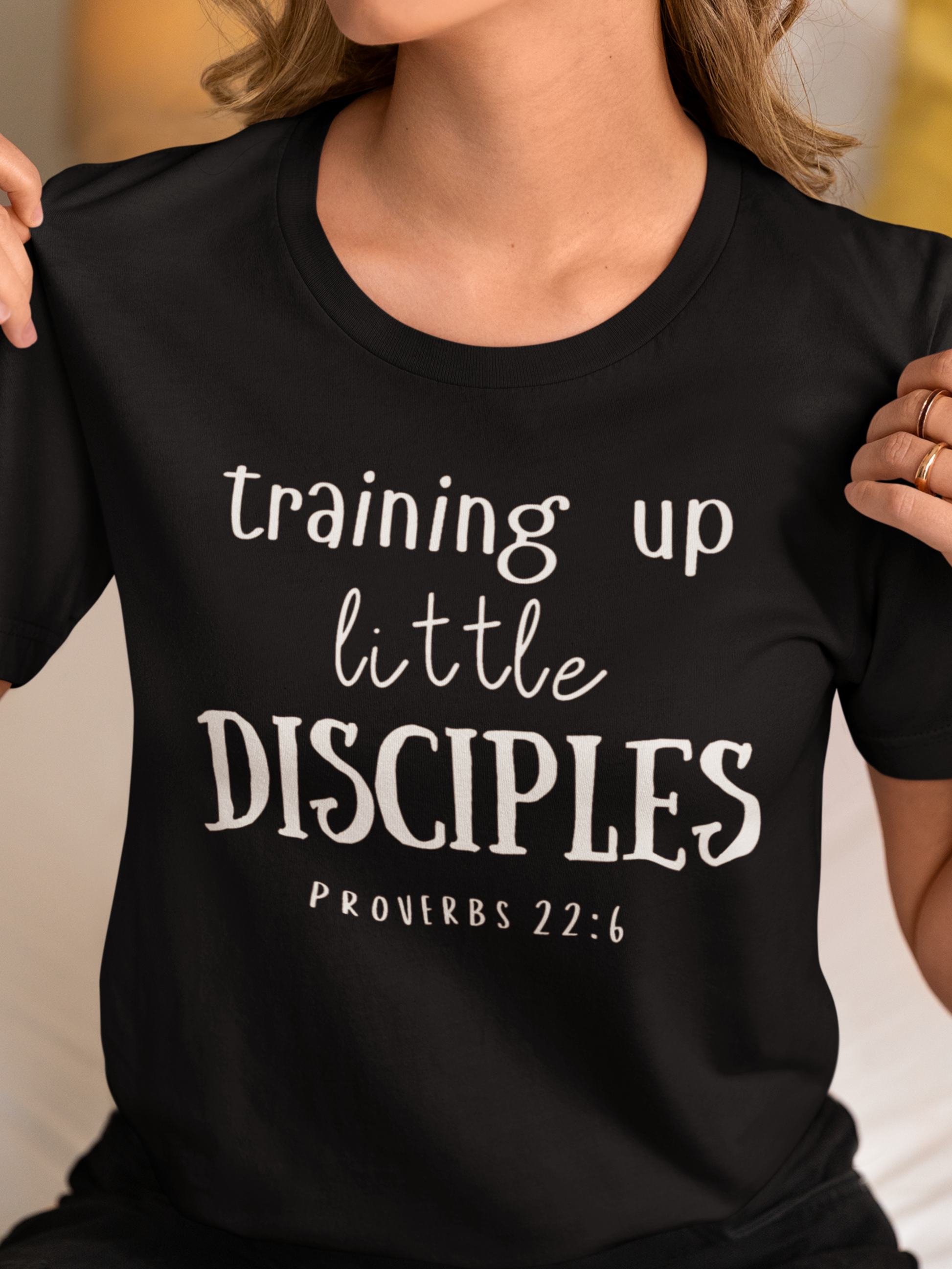 Black Mother's Day Christian T-Shirt with "Training Up Little Disciples" print design. Crew neck, short-sleeved, classic retail fit.