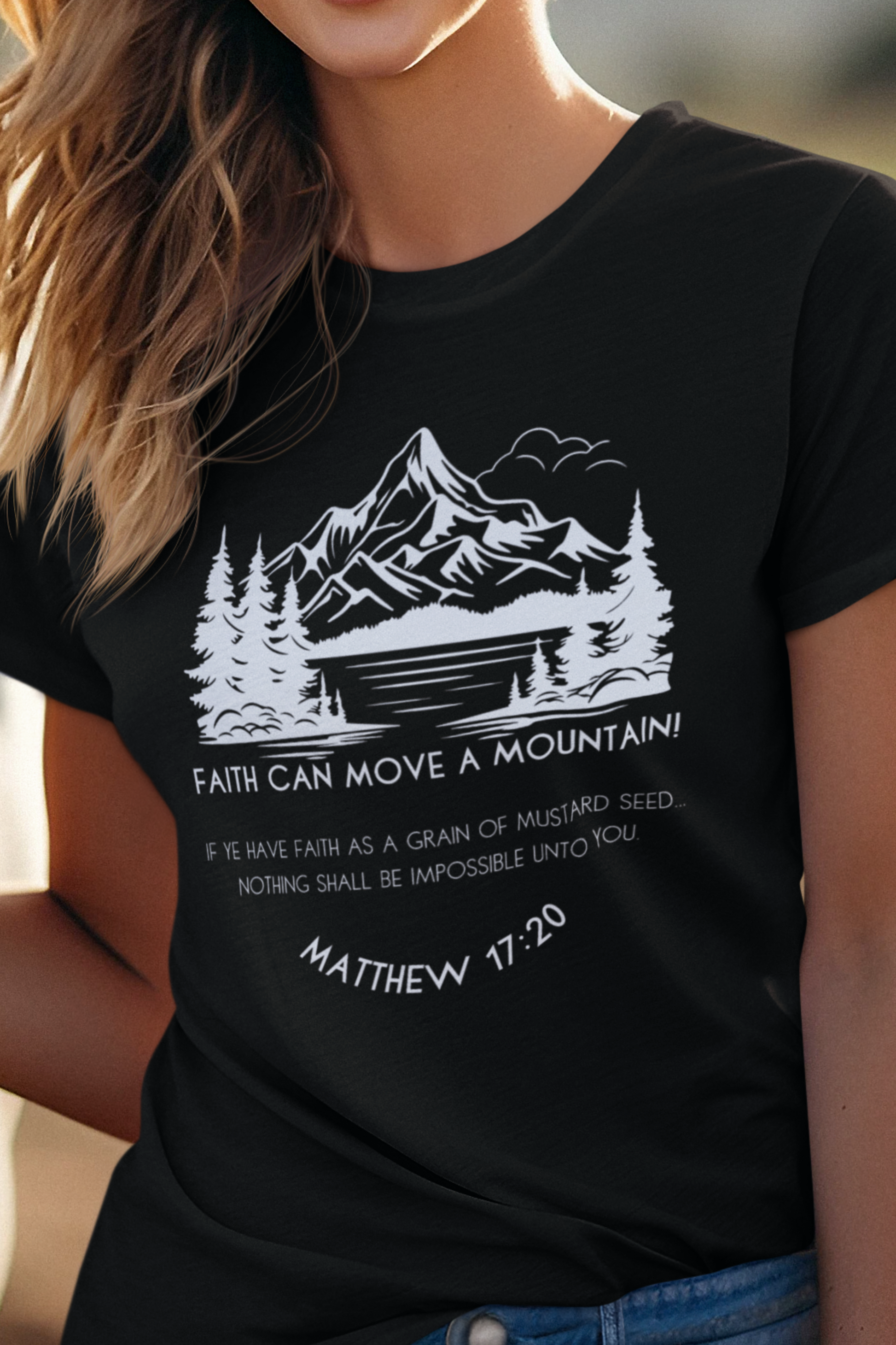 Black Christian T-Shirt for Ladies with "Faith can move a mountain. Matthew 17:20" print design.  T-shirt is crew neck, short-sleeved and a classic fit.