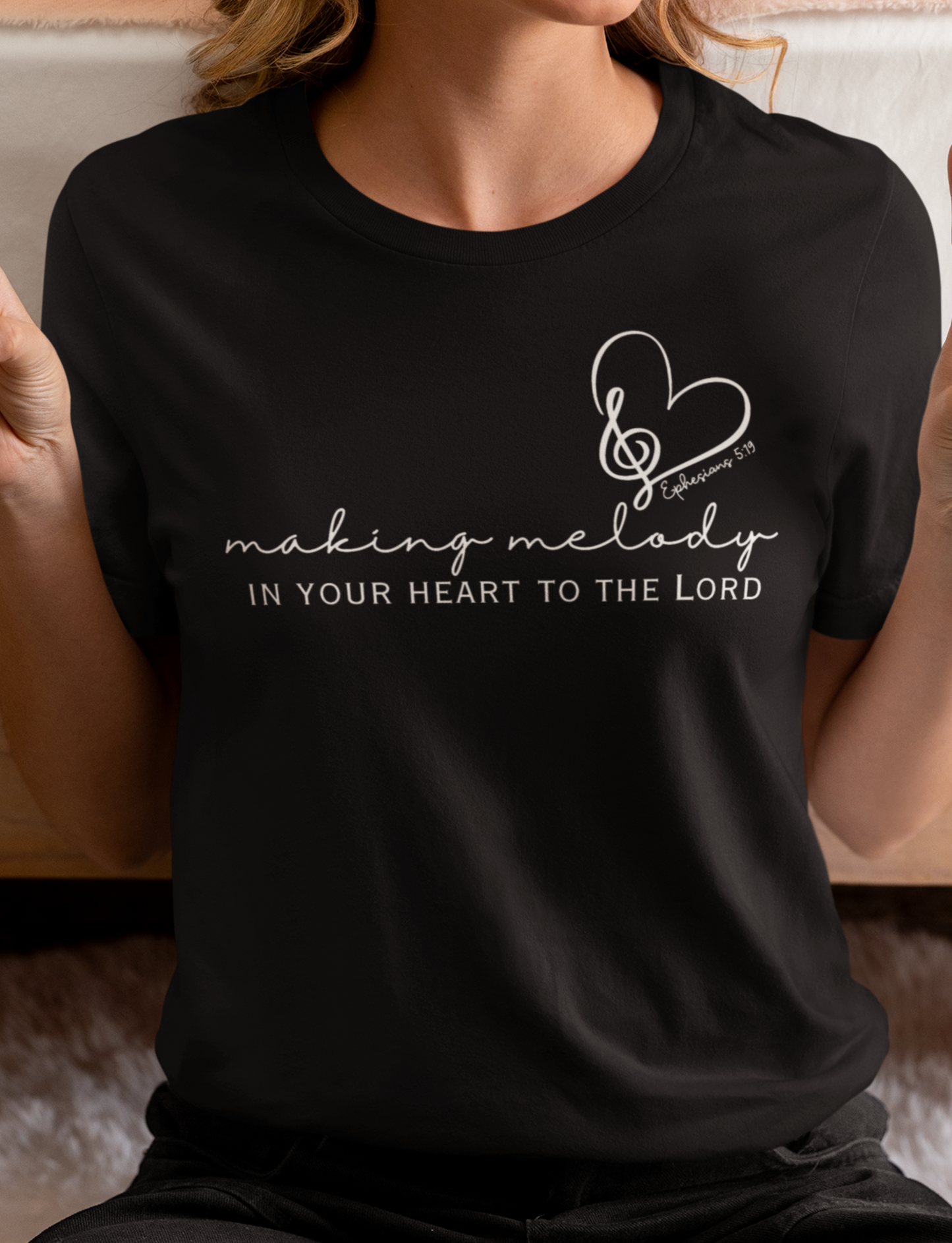 Black Christian Tshirt for Ladies with "Making Melody In your Hear to the Lord" print design. Crewneck, short-sleeved, classic fit.