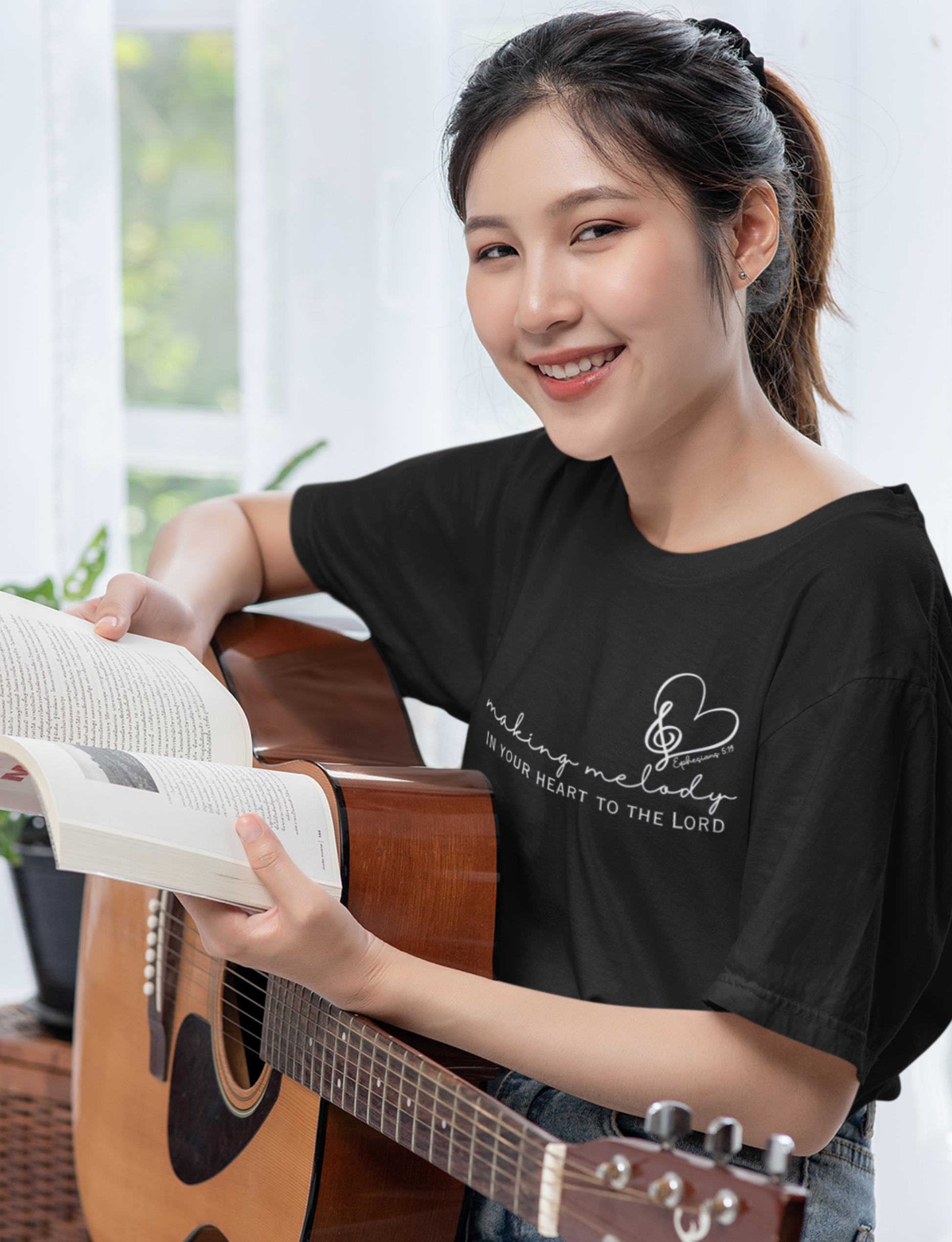 White Christian Tshirt for Ladies with "Making Melody In your Hear to the Lord" print design. Crewneck, short-sleeved, classic fit.