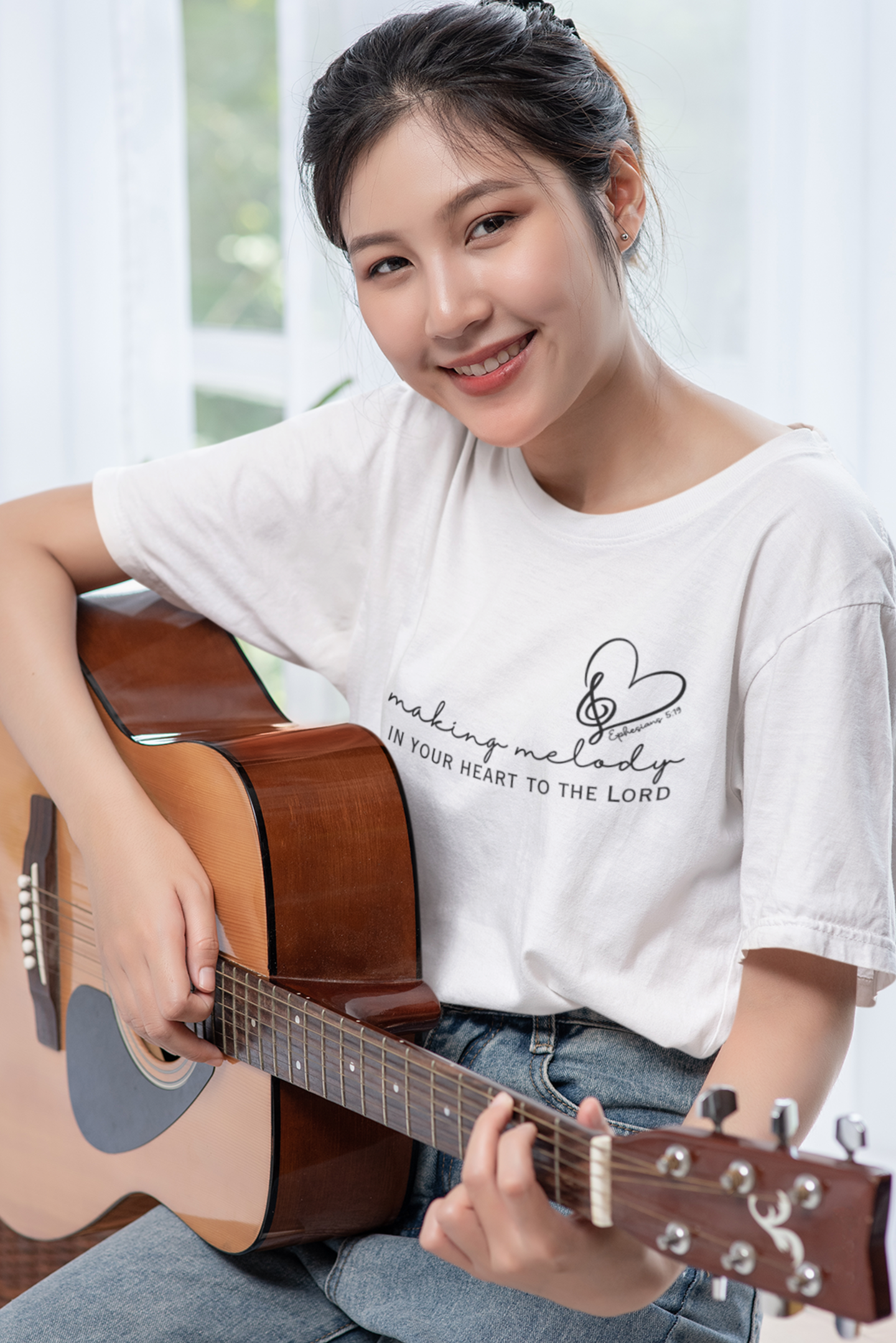 White Christian Tshirt for Ladies with "Making Melody In your Hear to the Lord" print design. Crewneck, short-sleeved, classic fit.