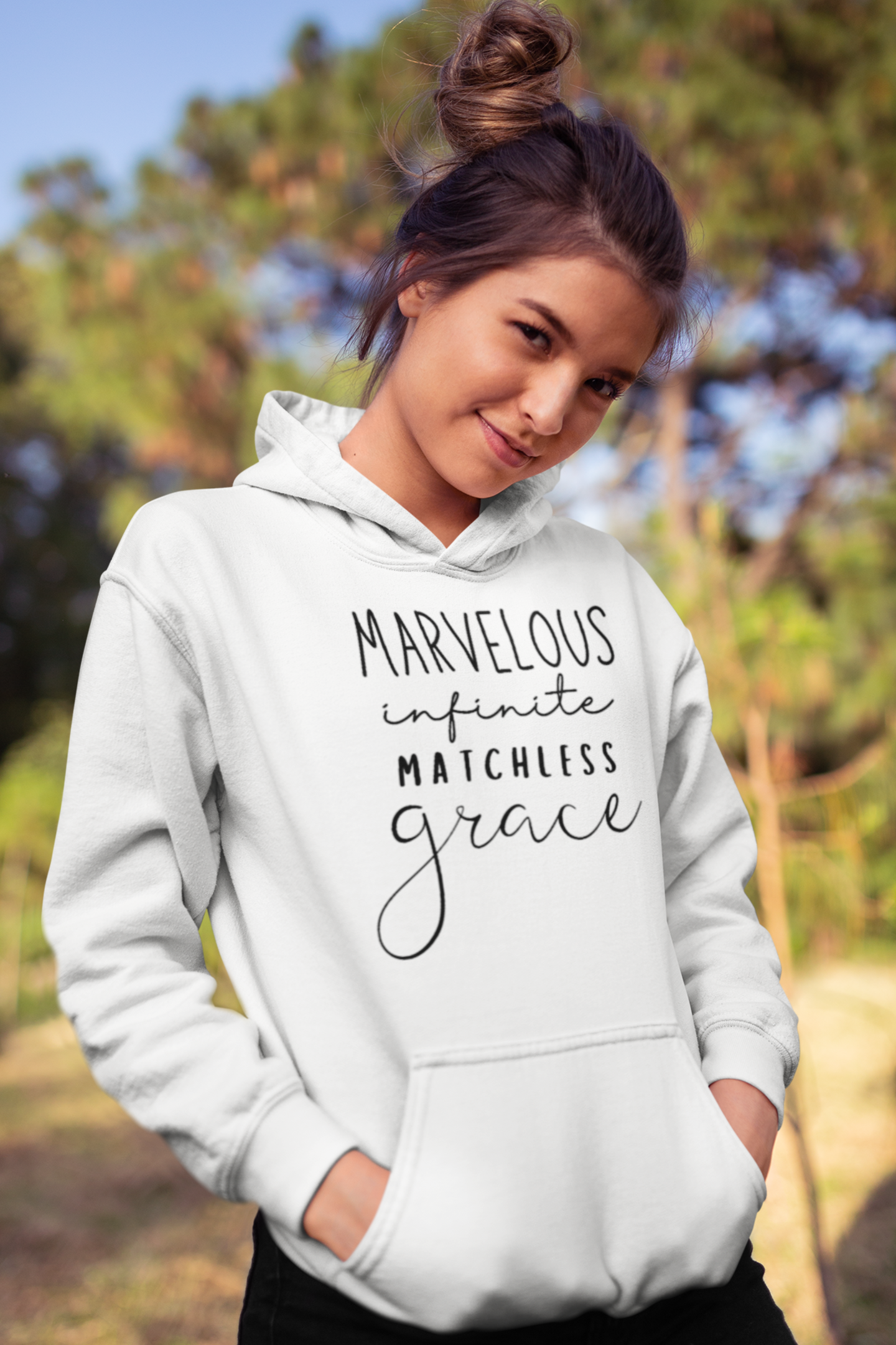 White pullover hoodie with "Marvelous Infinite Matchless Grace" print design. Premium hoodie with large pouch pocket on the front.