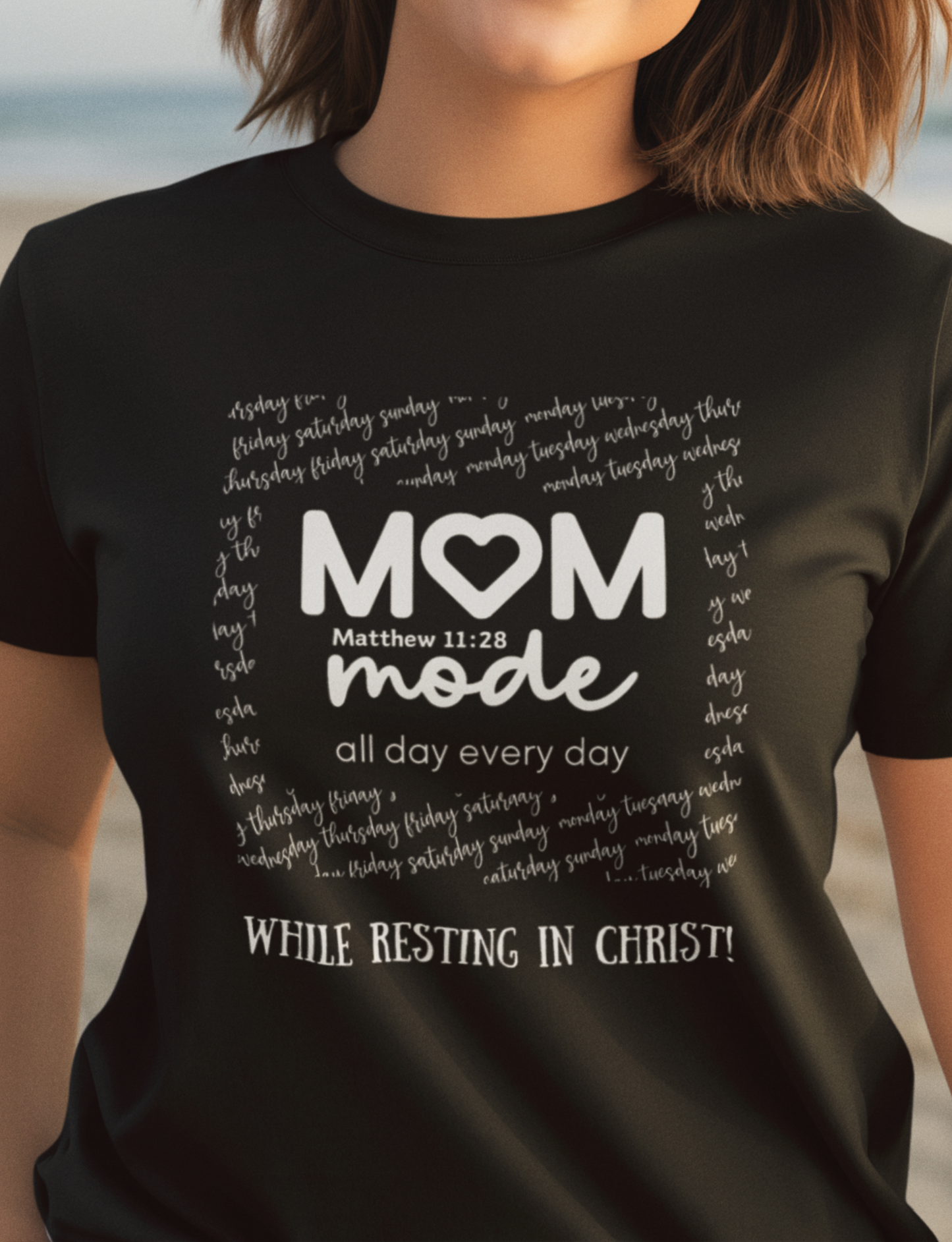 Black Mother's Day Christian T-Shirt with "Mom Mode, All Day Every Day While Resting in Christ" print design. Crew neck, short-sleeved, classic fit.