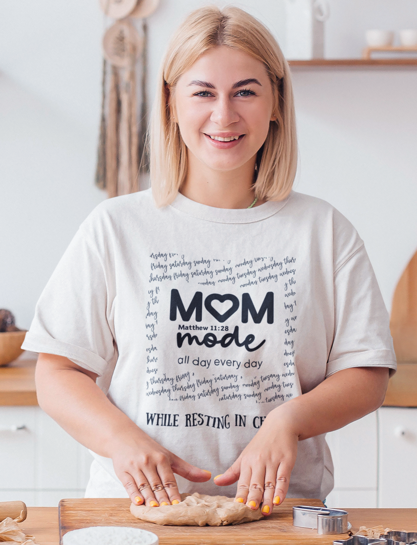 White Mother's Day Christian T-Shirt with "Mom Mode, All Day Every Day While Resting in Christ" print design. Crew neck, short-sleeved, classic fit.