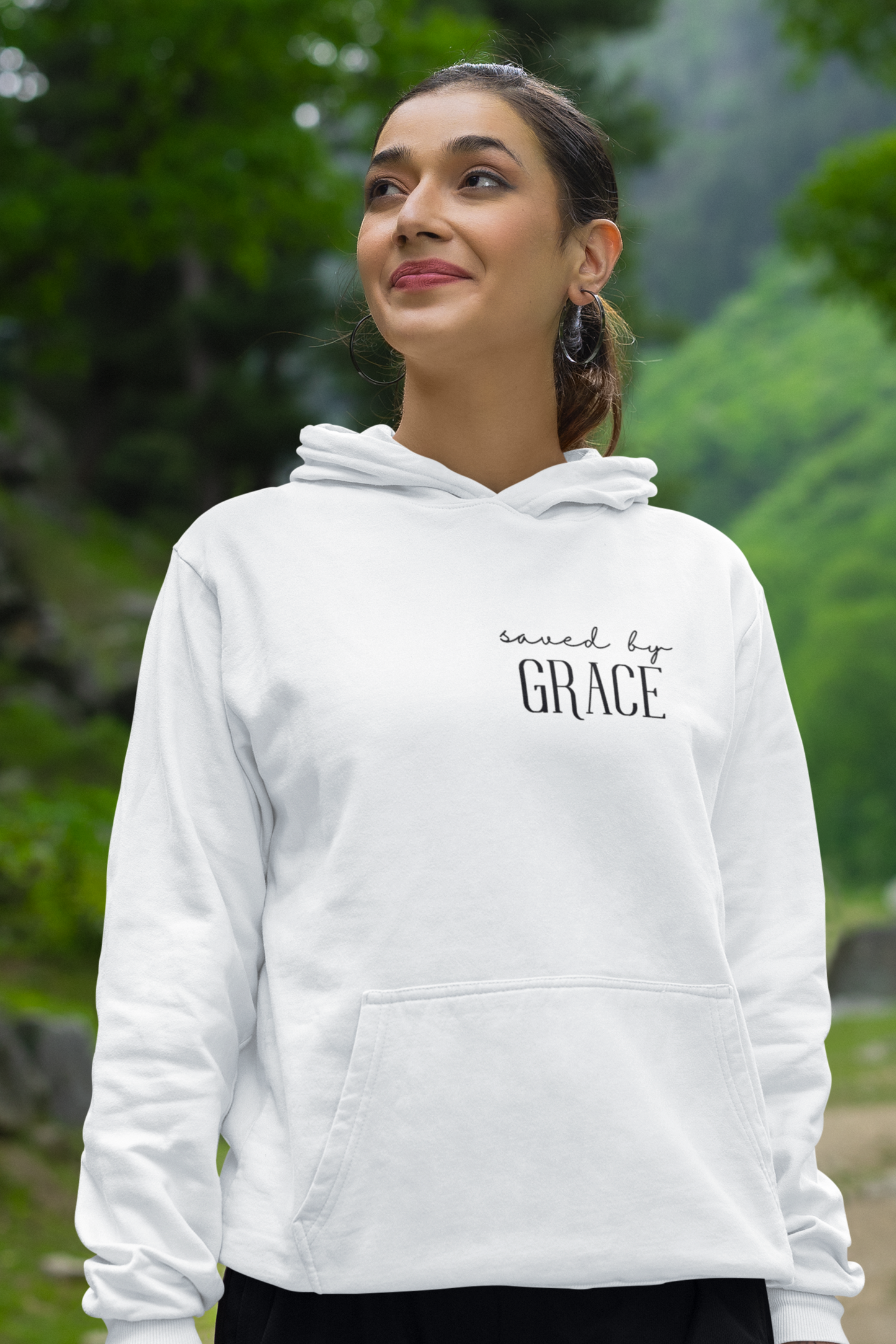 White Christian pullover hoodie with "Saved by Grace" print design at the front. With large front pouch pocket.